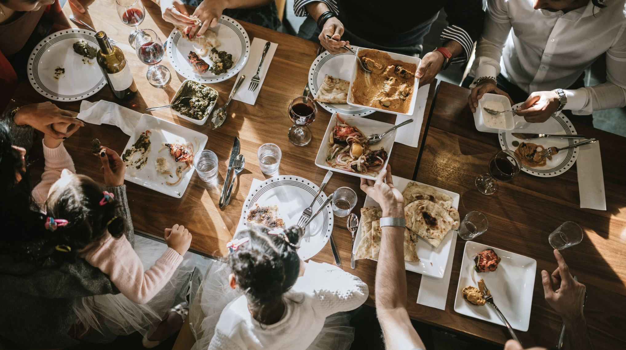 BIPOC Community Safety and Belonging starts at the kitchen table. people eating at a table.