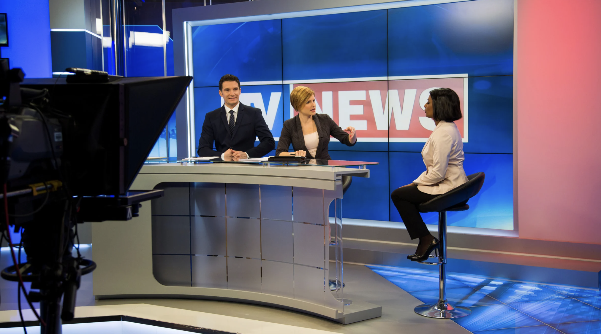 behind the scenes of a newsroom discussing weather